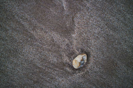 Colorful stone laying in the sandの写真素材