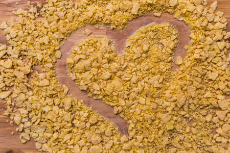 A heart shape made in cereal on a tableの写真素材