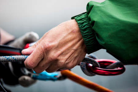 A man tying a knot in a rope