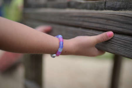 Closeup of a child playing on a playground on a sunny day