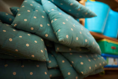Blue and dotted pillows in a stack at a schoolの写真素材