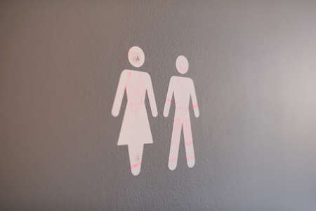 Closeup of a male and female bathroom sign at a school