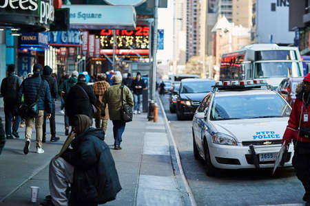 people and cars on the street in new york