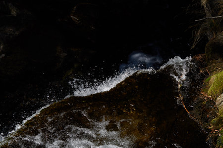 waves and white foam in a dirty lake