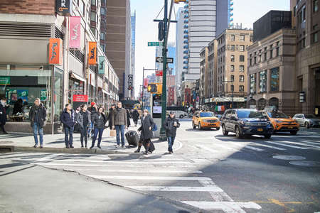 people waiting at crosswalk in new york city