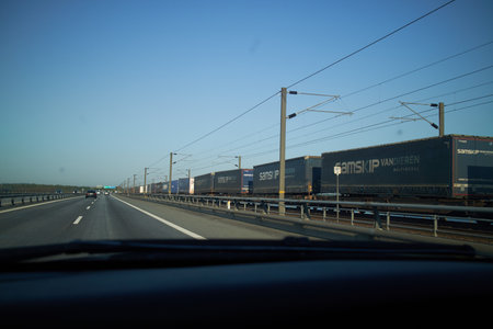a highway and train tracks with long train
