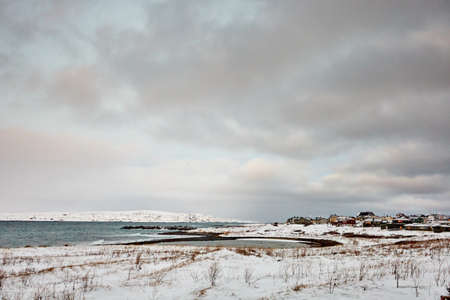 the beautiful beach in winter with snow and cloudsの写真素材