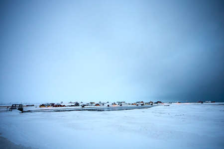 a snowy town by a lake in winter backgroundの写真素材