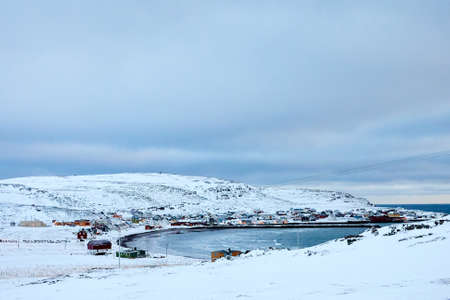 the beautiful beach in winter with snow and cloudsの写真素材