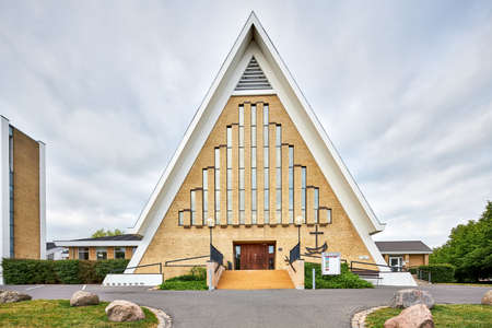 a yellow old triangle church building in denmarkの写真素材