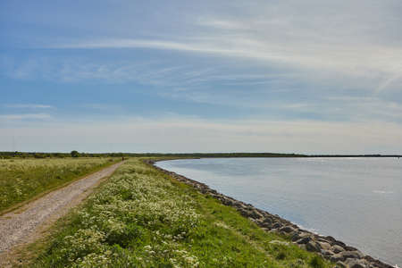 a beautiful blue lake by a large field