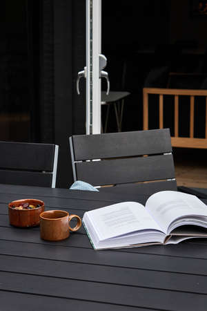 drinking tea and reading outdoors on the patioの写真素材