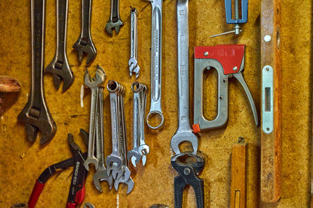 handyman tools hanging in a garden shed