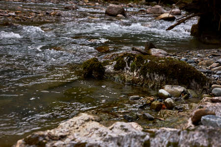 beautiful and clear water coming down a stream in the mountains