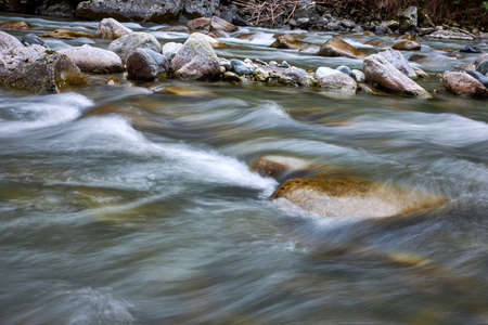 beautiful and clear water coming down a stream in the mountains