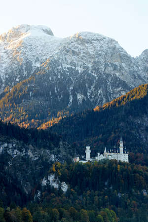 old white fairy tale castle in a mountain landscapeの写真素材