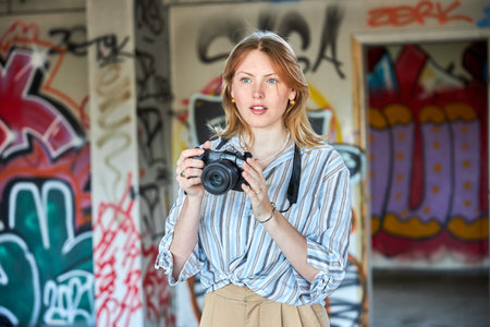 Red hair girl in a building with a cameraの写真素材