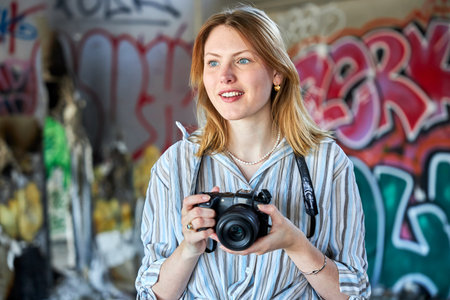 Red hair girl in a building with a camera