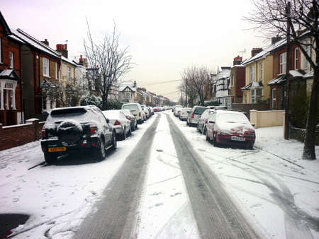 Snow covered cars out in the street, London, UK.