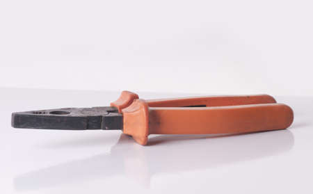 orange pliers on a white background の写真素材