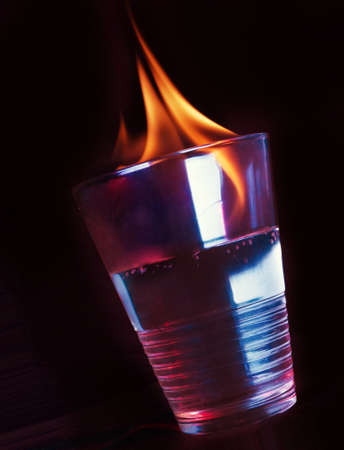a flaming glass of alcoholic water の写真素材