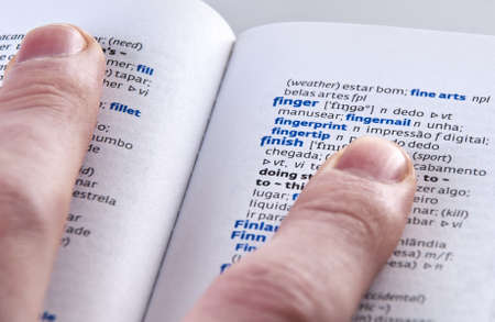 pointing and the word finger in a Portuguese  to english dictionary の写真素材