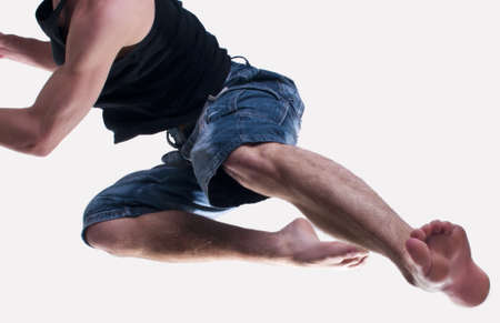 young man kicking forwardの写真素材