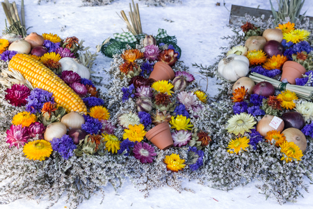 bunch of red and beige traditional german handcrafted plats of onions laying on a table for decoration or cookingの写真素材