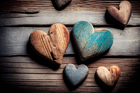 Old wooden hearts on rustic wooden background. Valentines day concept.の素材