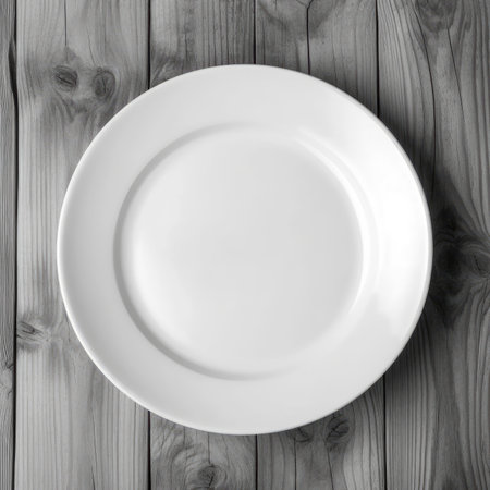 Empty plate on wooden background. Top view with copy space for your text.の素材