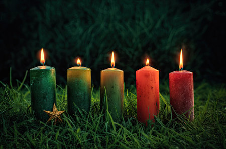 Burning candles on green grass with bokeh background and copy spaceの素材
