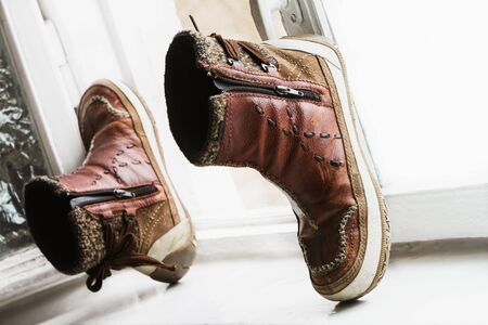 Old shoes on the windowsillの写真素材