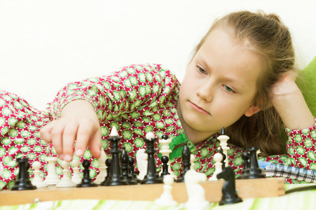 Teen girl playing chessの写真素材