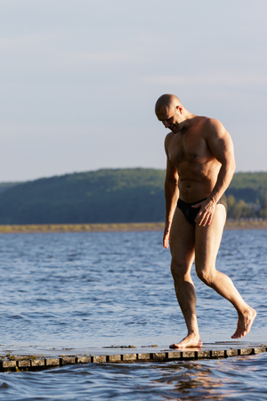 Strong man on the lake.の写真素材