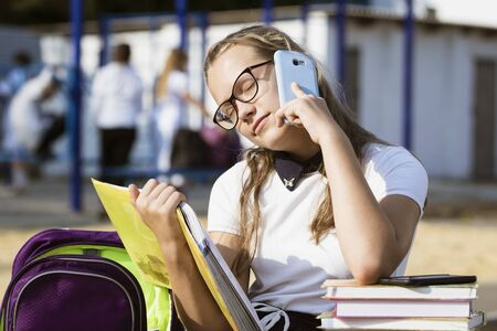 Portrait of a schoolgirl with glasses outdoorsの写真素材