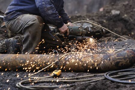 Worker with grinder at workの写真素材