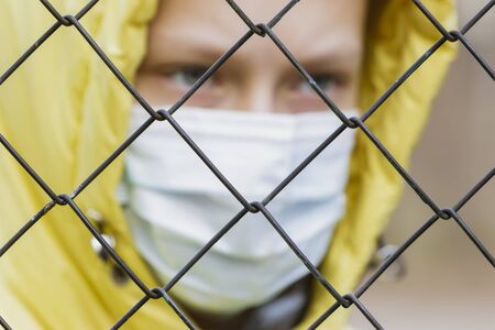 Girl in a medical mask in quarantine, streetの写真素材