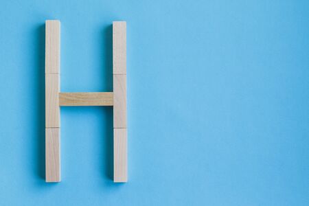 Letter of the English alphabet from a tree on a background with copy space