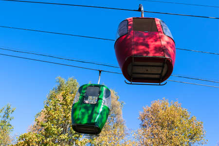 Cable car with colored cabins in autumnの写真素材