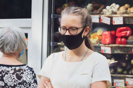 Portrait of a girl in a protective mask near food