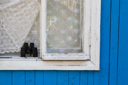 Binoculars in the house on the window, travelの写真素材