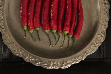 Red hot chili pepper on an old trayの写真素材