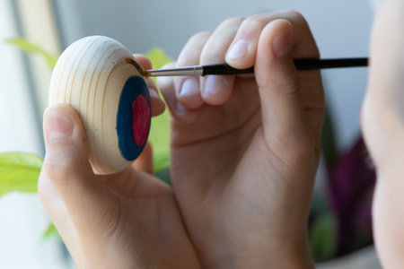 A child draws on an Easter egg. Childrens creativity.の写真素材