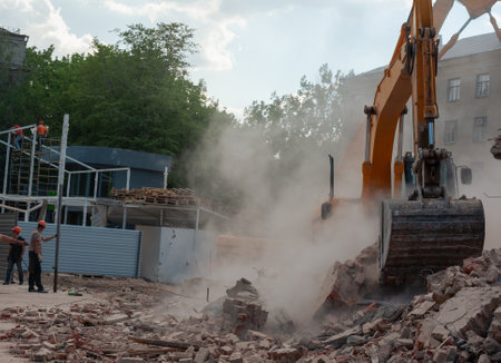 Demolition of building. Excavator breaks old house. Freeing up space for construction of new...