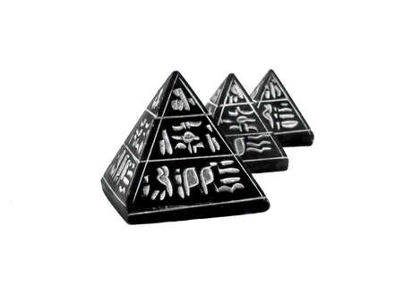 Three black pyramids with Hieroglyphen on the white backgroundの写真素材
