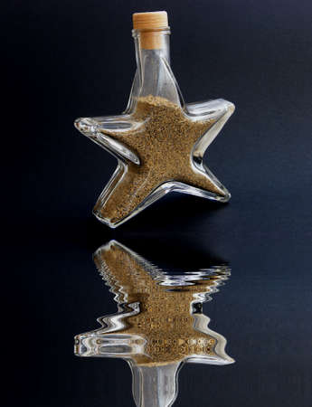 A bottle with the sand in the water level pictureの写真素材