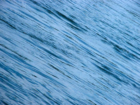Blue, diagonal water waves as a background.