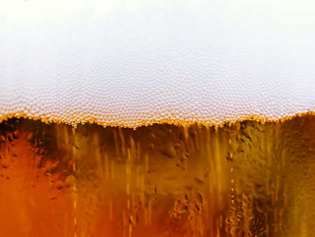 A glass with the cold beer, as a background