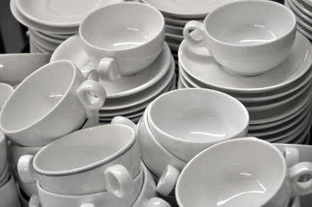 Stacked, white cups and platesの写真素材