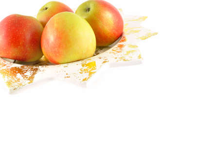 Four apples in a dish and a white background                          の写真素材